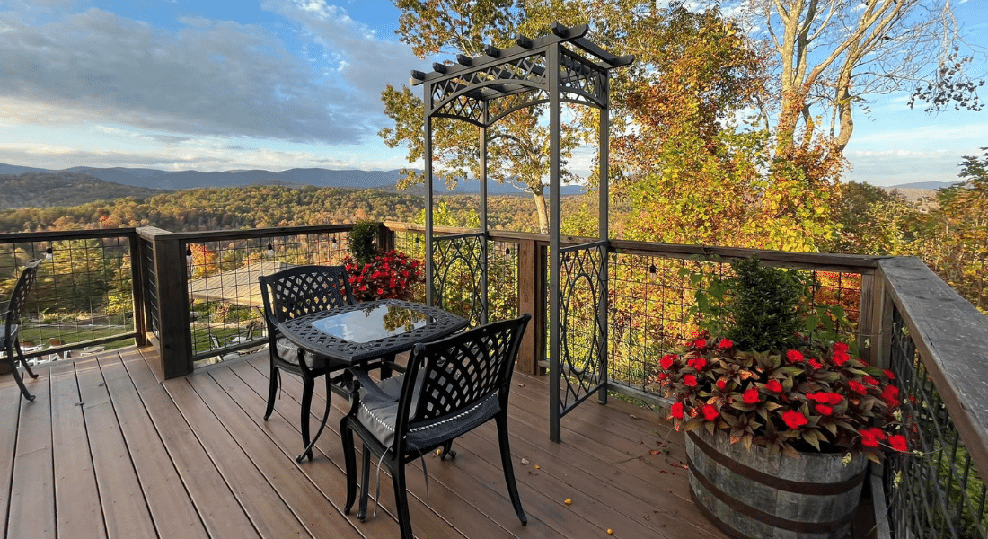 A couple sitting in the gazebo with flowers and greenery all around