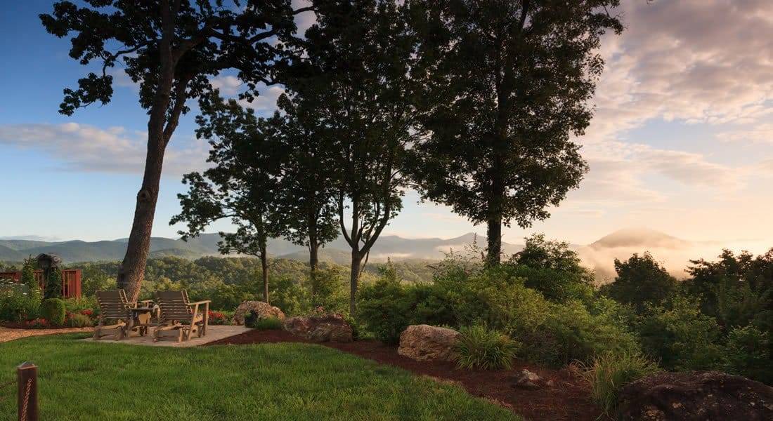 Looking out over the lawn with view of trees and mountains.