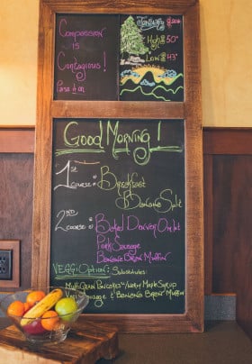 Chalk board framed in wood with todays menu written in yellow and red