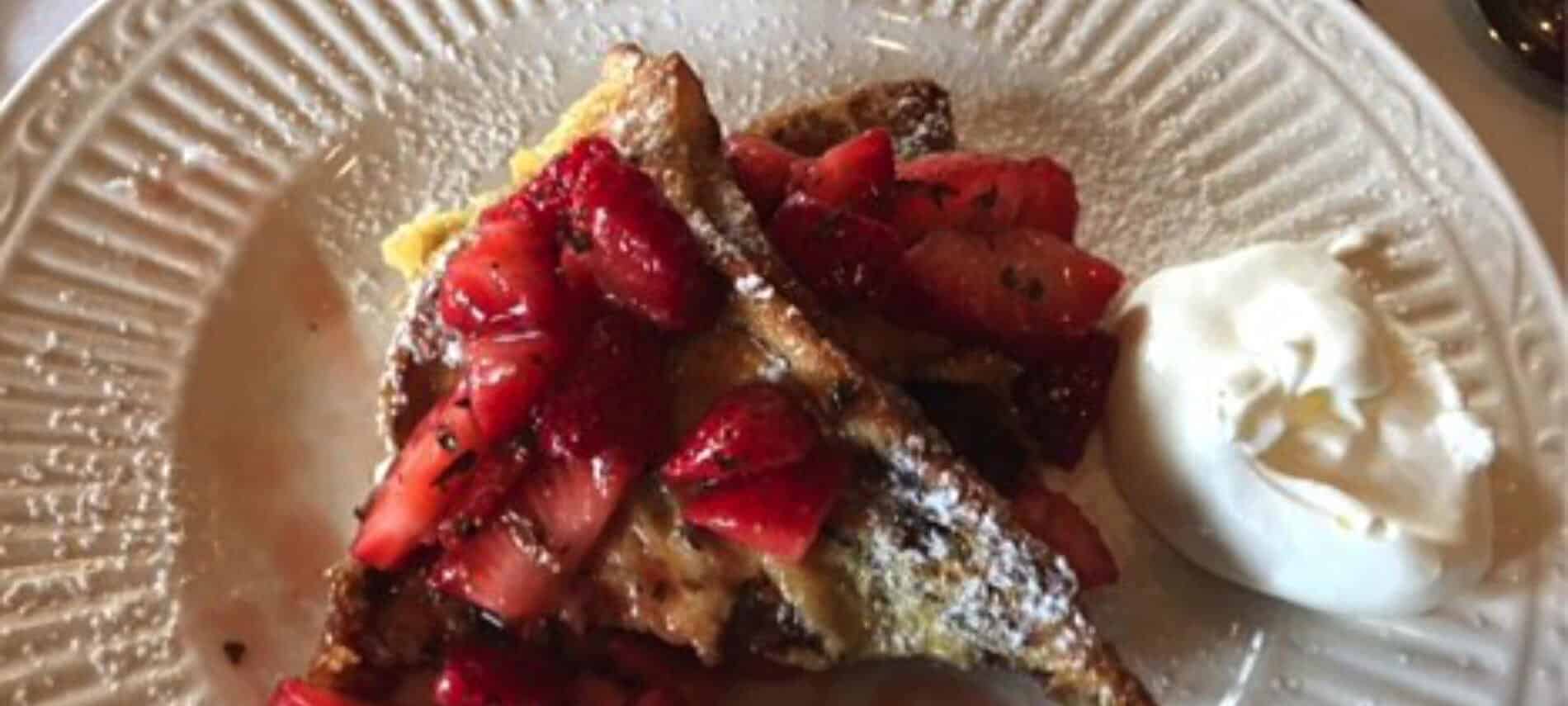 Red strawberries with french toast and a dollop of better on the side