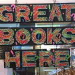 A photo of a sign in the bookstore that reads, "Great books here".