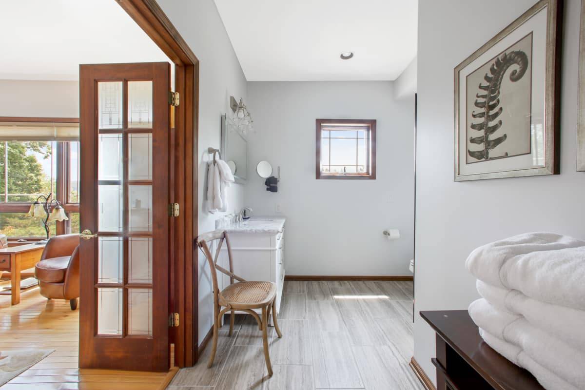 Nice clean White Shower stall with a freestanding electric fireplace.