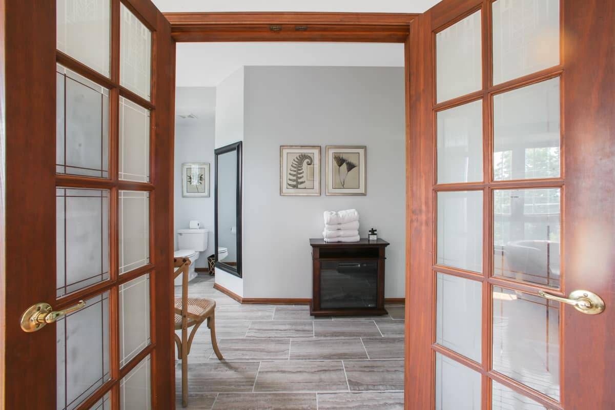 Nice clean White Shower stall with a freestanding electric fireplace.