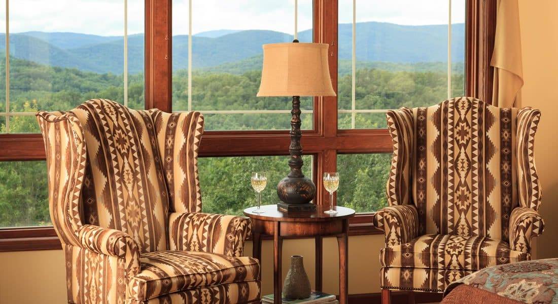 Two Astec tall back chairs infront of three windows with an incredible view of the mountains.